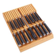 an assortment of knives in a wooden holder