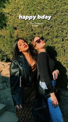 two women standing next to each other with the words happy day written on top of them