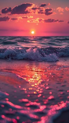 the sun is setting over the ocean with pink and purple hues on it's water