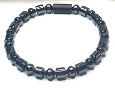 Experience the healing benefits of magnetic therapy with our Men's Magnetic Hematite Therapy Bracelet. Made with high-quality AAA grade magnetic hematite, this black single bracelet is designed to promote body health and wellness. Crafted with 90lb extra strength copolymer craft line, this bracelet offers long-lasting wear. The high strength magnetic clasp provides added convenience and security. To ensure a perfect fit, please measure your wrist using a fabric or sewing tape measure and add ½ t Black Magnetic Hematite Bracelet, Black Hematite Magnetic Bracelets, Black Hematite Magnetic Bracelet, Black Magnetic Hematite Bracelets, Sewing Tape Measure, Single Bracelet, Magnetic Jewelry, Bracelet Simple, Bracelet Black