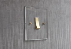 a light switch mounted to the side of a wall with a metal frame on it