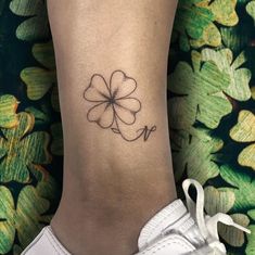 a small four leaf clover tattoo on the ankle