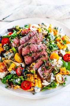 steak and corn salad on a white plate