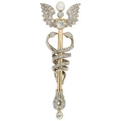 A late Victorian yellow gold and diamond Caduceus brooch, the winged staff white claw-set throughout with old brilliant-cut and rose-cut diamonds, a natural pearl raised to the centre, two diamond-set serpents entwined around the staff, all white claw set to an open back yellow mount with brooch fittings, circa 1890, approximate length 57 x 20mm, gross weight 7.7 grams Should you choose to make this purchase we will delighted to send it to you in a Bentley & Skinner handmade leather case packed in a gift-wrapped Bentley & Skinner black and gold presentation box. Shortly afterwards we will send you on a valuation for insurance purposes for your reference and safekeeping. White Claw, Antique Brooches, Diamond Brooch, Natural Pearl, Dream Board, Diamond Set, Rose Cut Diamond, Natural Pearls, Handmade Leather