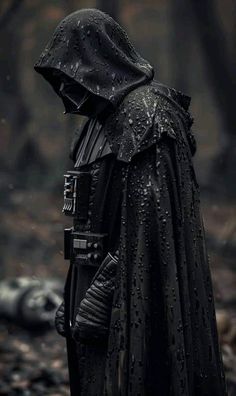 darth vader standing in the dark forest with rain drops on his face and hood