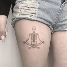 a woman with a skeleton tattoo on her thigh