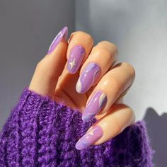 While sheer polishes are top of mind, let's ogle over this pretty pale purple mani. With silver swirls and sparkle star designs, it looks whimsical and witchy, not to mention magical. Purple Christmas Nails, Nail Ideas Purple, Christmas Nails 2023, Christmas Nail Ideas, Purple Nail Art, February Nails, Purple Nail Designs, Holiday Nail Designs