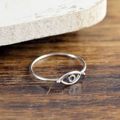 Silver Evil Eye Ring This Dainty & Adorable Evil Eye Ring is a the perfect gift for someone SPECIAL! This sterling silver evil eye ring is perfect for stacking. While evil eye amulets were first recorded by the Mesopotamia's about 5,000 years ago on clay tablets, belief in their protective power is still strong in many parts of the world. People attach an evil eye amulet to everything they wish to protect from envy and jealousy. Elias Bouchard, Eye Ring Silver, Evil Eye Ring Silver, Portrait Jewelry, Moissanite Engagement Ring White Gold, Moonstone Engagement Ring Set, Jewelry Stacking, Morganite Engagement Ring Set, Beach Bracelets