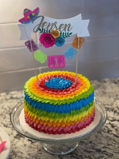 a multicolored cake sitting on top of a counter