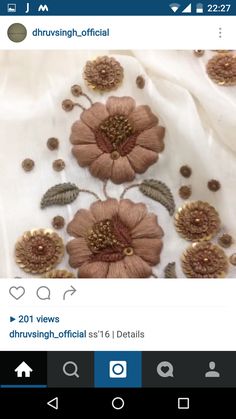 an image of some flowers on a white cloth with gold accents and leaves in the middle