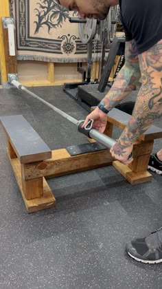 a man working on a bench in a gym