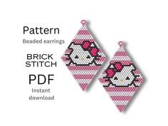 two cross stitch earrings with pink and white designs on them, one has a skull in the