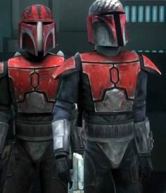 two people in star wars costumes standing next to each other, one wearing a helmet