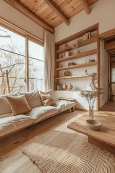 a living room filled with lots of furniture and wooden shelves next to a large window