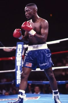 a man standing next to a boxing ring