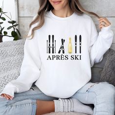 Step out of the ski slopes and into style with this cozy and cute Apres Ski sweater. Featuring an apres ski design, this comfortable skiing sweater is perfect for those chilly days. The colors and unique pattern give this sweater a retro feel. Whether you're lounging around the cabin or hitting the town with your friends, this Apres Ski sweatshirt will keep you warm and looking your best. Information - Gildan 18000 Unisex Sweatshirt - 50% Cotton 50% Polyester - Ribbed knit collar - Printed with the highest quality and durability Care Instructions - Machine wash: warm (max 40C or 105F) - Non-chlorine bleach - Tumble dry on low or lay flat to dry - Do not iron directly into design - Do not dryclean Sizing - Sizes are unisex - It fits true to size, or size up for an oversized fit. - Please re Casual Crew Neck Sweater For Ski Season, Casual White Sweatshirt For Winter Sports, Casual Tops For Winter Sports, Sporty Crew Neck Skiing Tops, White Crew Neck Sweatshirt For Winter Sports, Sporty Crew Neck Tops For Skiing, Casual Skiing Tops, Casual Winter Skiing Tops, White Long Sleeve Sweatshirt For Winter Sports