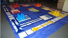 a table covered in blue tarp with construction cones and markers on top of it