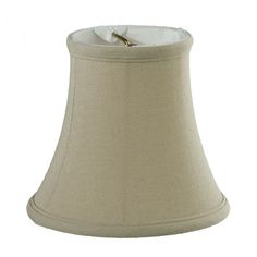 a beige lamp shade with a gold ring on the bottom and white linen linings