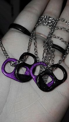 two black and purple handcuffs on a hand