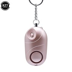 a metal keychain with a pink object on it's back and the word,