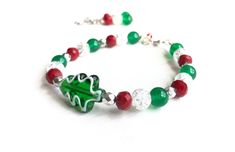 Christmas tree bracelet is fun & festive! Perfect for finishing off your holiday attire quickly and easily. It's bright red, white and green hues makes an impressive statement around your wrist. With this Christmas jewelry set you can be festive & fashionable! Christmas Jewelry for Women * Christmas tree gifts for her! * Christmas tree lampwork bead * Colorful red, white and green beads * Total length 8.25 inches, Different lengths available on request.  * Made with silver lobster clasp * Strung Christmas Party Beaded Bracelets, Green Christmas Gift Bracelets, Green Bracelets For Christmas Gift, Red Beaded Bracelets For Christmas Gifts, Green Christmas Bracelet Gift, Green Bracelets For Christmas Party, Green Christmas Festive Bracelets, Christmas Gift Green Bracelet, Christmas Holiday Bracelet Jewelry