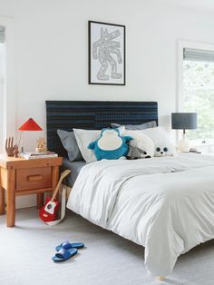 a bed with white sheets and pillows in a bedroom