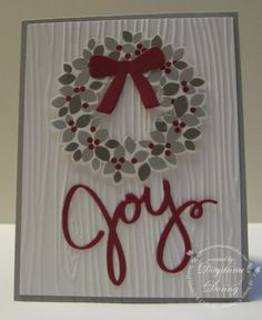 a christmas card with a wreath and the word joy on it