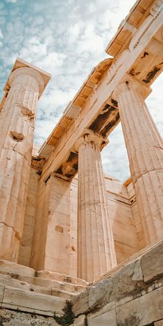 two large stone pillars against a cloudy sky