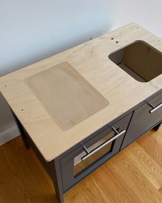 an unfinished workbench with a sink in the center and drawers on each side