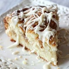 a piece of cake sitting on top of a white doily covered in icing