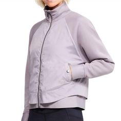 Under Armour Misty Copeland Signature Layer Light Jacket New With Tags Size: Small Color: Tetra Gray (It Has A Lavender / Lilac Tint!) So Soft & Comfy High Neck Loose: Fuller Cut For Comfort Unique, Ultra Lightweight Fabric Constructed With Internal Air Pockets To Trap Added Warmth Without Sacrificing Breathability Translucent Woven Panels For Added Durability 4 Way Stretch Construction Material Wicks Sweat & Dries Really Fast Snap Button Pockets Shaped Bottom Hem W Elastic Band Ptp: 21.5" Lengt Purple Casual Track Jacket For Fall, Casual Purple Track Jacket For Fall, Purple Track Jacket For Fall Sports, Purple Outerwear For Spring Layering, Spring Purple Outerwear For Layering, Sporty Purple Track Jacket For Fall, Winter Purple Outerwear With Ribbed Cuffs, Purple Winter Outerwear With Ribbed Cuffs, Purple Sports Outerwear For Fall