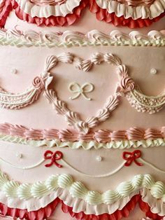 a large cake decorated with hearts and ribbons