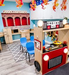 the children's playroom is decorated in bright colors and features a fire engine