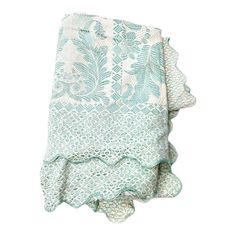 a white and blue towel with green leaves on it