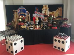 a casino themed dessert table with black and white polka dot dices on the tables