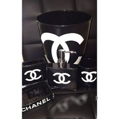 a black and white chanel set on top of a leather couch next to other items