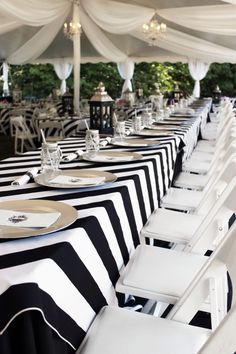 the tables are set with black and white striped tablecloths