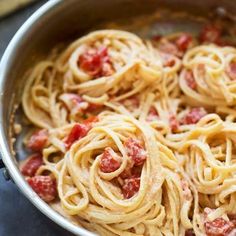 a pan filled with pasta and sauce on top of a table