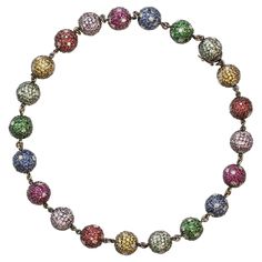 A unique and modern bead necklace featuring multicolor gemstones set in a pave fashion with diamond accents. The necklace has a total of 21 balls including the clasp. Each ball is set with natural stones : Blue sapphires, pink sapphires, rubies, tsavorite garnets, orange sapphires, green sapphires. The estimated weight of the diamonds is 8.40 carats, HI color SI clarity. The estimated weight of the color stones is 45 carats, with very good color overall. The necklace is set in 18 karat black rho Pave Beads, Tsavorite Garnet, Color Stones, Orange Sapphire, Green Sapphire, Black Rhodium, Pink Sapphire, Bead Necklace, Pave Diamonds