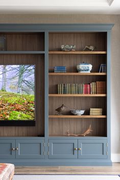 an entertainment center with built in bookshelves and shelves filled with books, vases and other decorative items