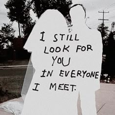 a sign that says i still look for you in everyone i meet on the sidewalk