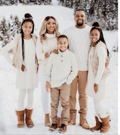 a family posing for a photo in the snow