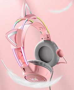 a pair of headphones hanging from the side of a pink wall with an image of a cat on it