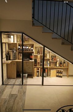 an open living room with stairs leading up to the second floor and storage area in the back