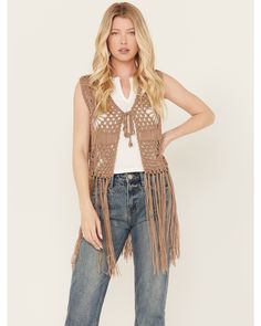 Model is 5'8" wearing a size small. Open front styling with self tie closure. Solid taupe design. Crochet design with long fringe details. Fall Festival Vest With Fringe, Fall Sleeveless Vest With Tassels, Spring Sleeveless Vest With Tassels, Casual Fringed Vest For Fall, Sleeveless Tassel Vest For Spring, Brown Bohemian Vest With Fringe, Bohemian Brown Vest With Fringe, Brown Bohemian Fringe Vest, Bohemian Brown Fringe Vest