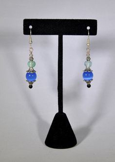 Stainless steel earrings with silver decorative accents and blue, light green and black beads.  This is a hand-made object.  The ear wires are hypoallergenic. Blue Round Beads Pierced Earrings, Blue Pierced Earrings With Round Beads, Steel Earrings, Decorative Accents, Stainless Steel Earrings, Green And Black, Green And Blue, Blue Beads, Black Beads