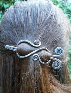 a close up of a woman's head with hair clips in the shape of waves