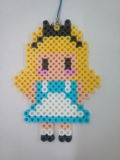 an ornament made out of legos with a girl in blue and white dress