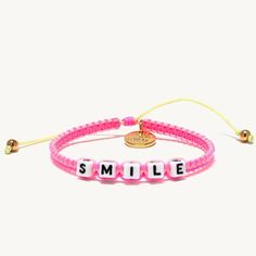 Pretty Bright Pink Woven Bracelet That Says Smile Gold Accents Adjustable Size Gift Yourself Or Gift A Friend Adjustable Pink Friendship Bracelets, Adjustable Pink Resizable Braided Bracelets, Adjustable Resizable Pink Braided Bracelets, Pink Adjustable Bracelet Jewelry, Pink Adjustable Friendship Jewelry, Pink Adjustable Length Jewelry For Friendship, Pink Beaded Braided Bracelet For Friendship, Pink Adjustable Braided Bracelet, Casual Pink Braided Bracelets As Gift