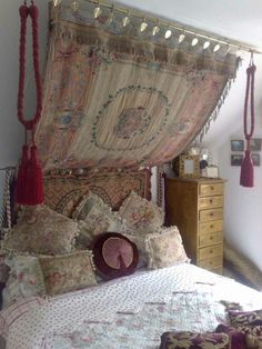 a bedroom with a canopy bed and many pillows